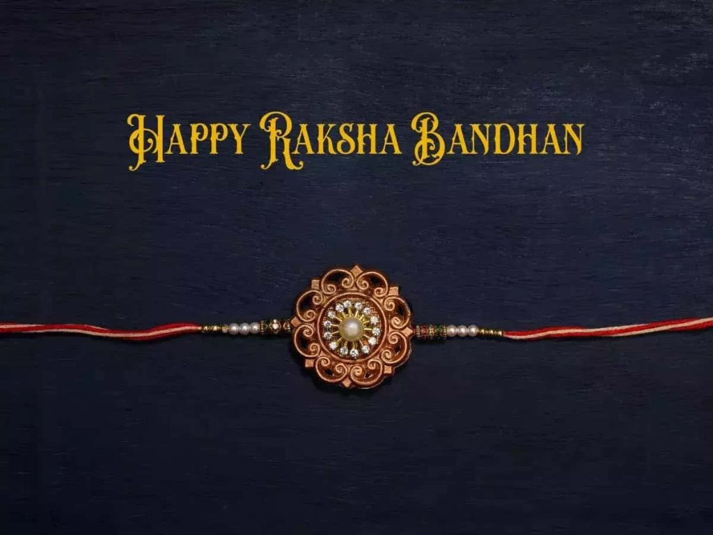 Elegant Happy Raksha Bandhan wallpaper with ornate copper Rakhi pearl stones on blue background