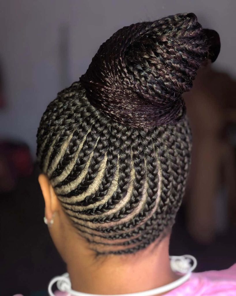 Elegant cornrows braided into a sleek voluminous high bun showcasing intricate texture hairstyle Wallpaper