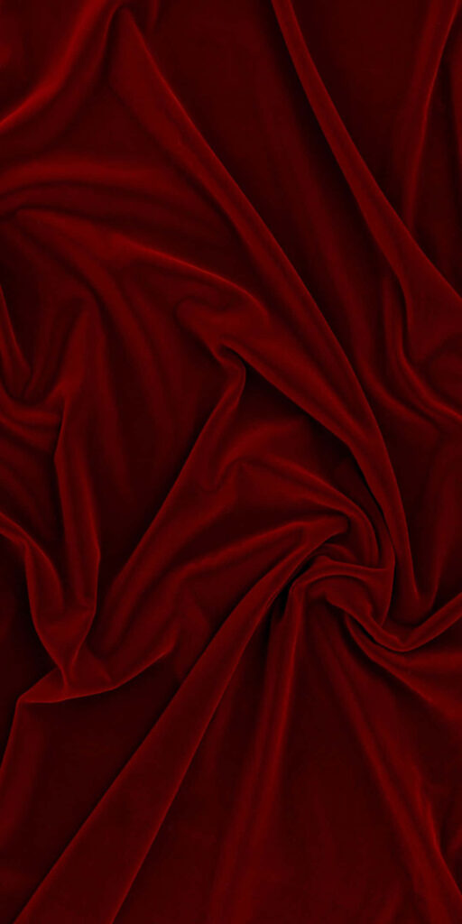 Elegant Dark Red Textured Fabric Wallpaper Background with Soft Folds
