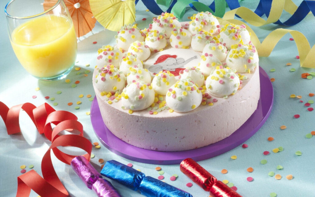 Elephantlicious Birthday Delight: A Festive Cake Drizzled with Sweet Candies Wallpaper