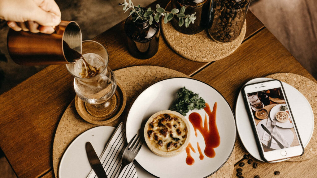 Elegant Dining Setup: Gourmet Dish & Beverage Pour with Smartphone Wallpaper