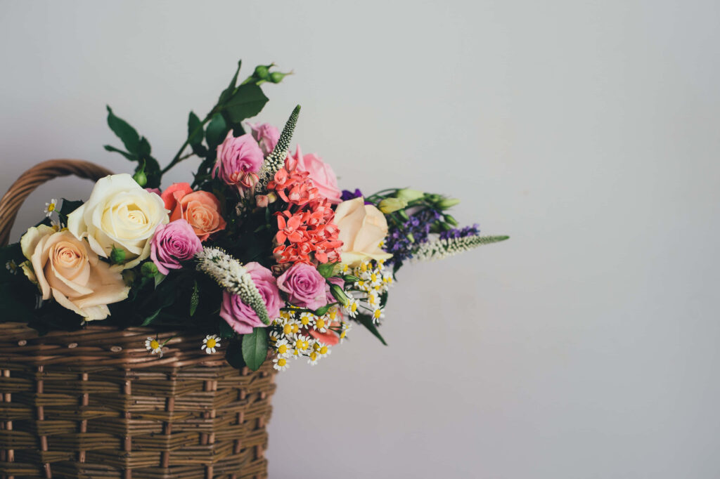 Vibrant Flower Basket Arrangement on Neutral Background Wallpaper