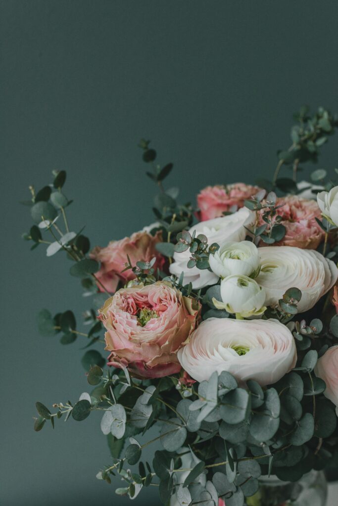 Elegant Floral Wallpaper: Pink Roses & Ranunculus with Eucalyptus Background