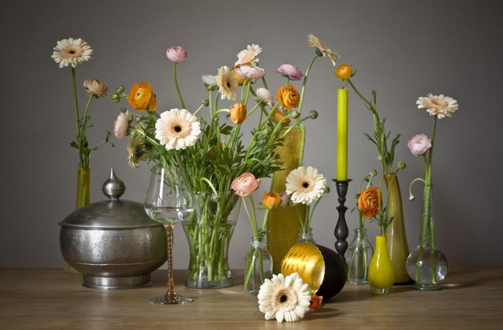 Elegant Floral Wallpaper: Gerberas and Ranunculus in Glass Vases