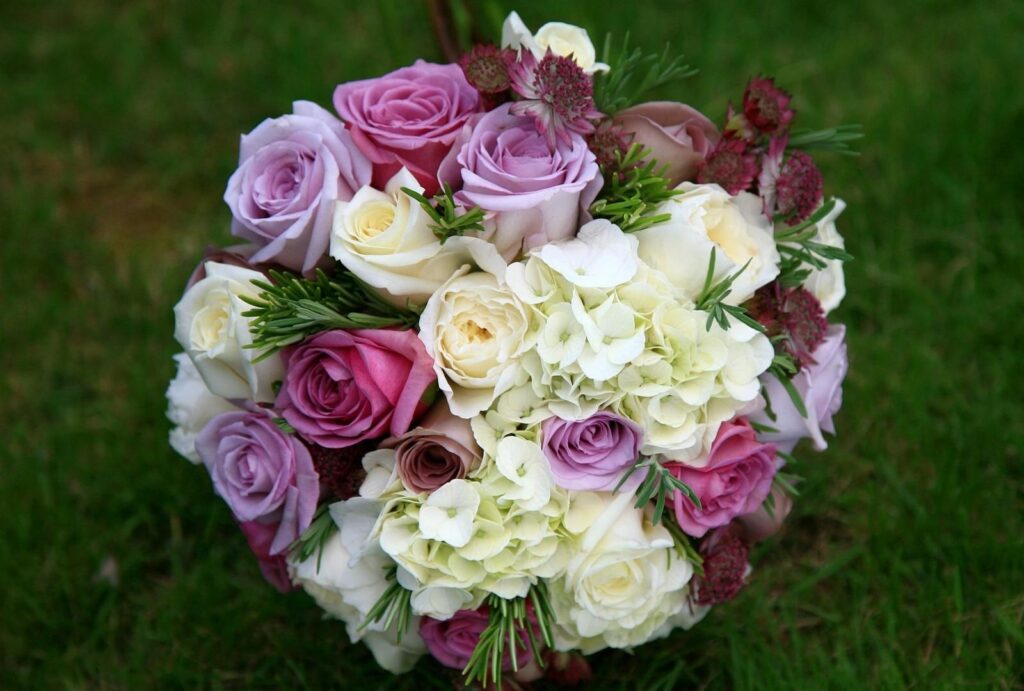 Elegant Floral Wallpaper: Pastel Bouquet on Lush Green Grass Background