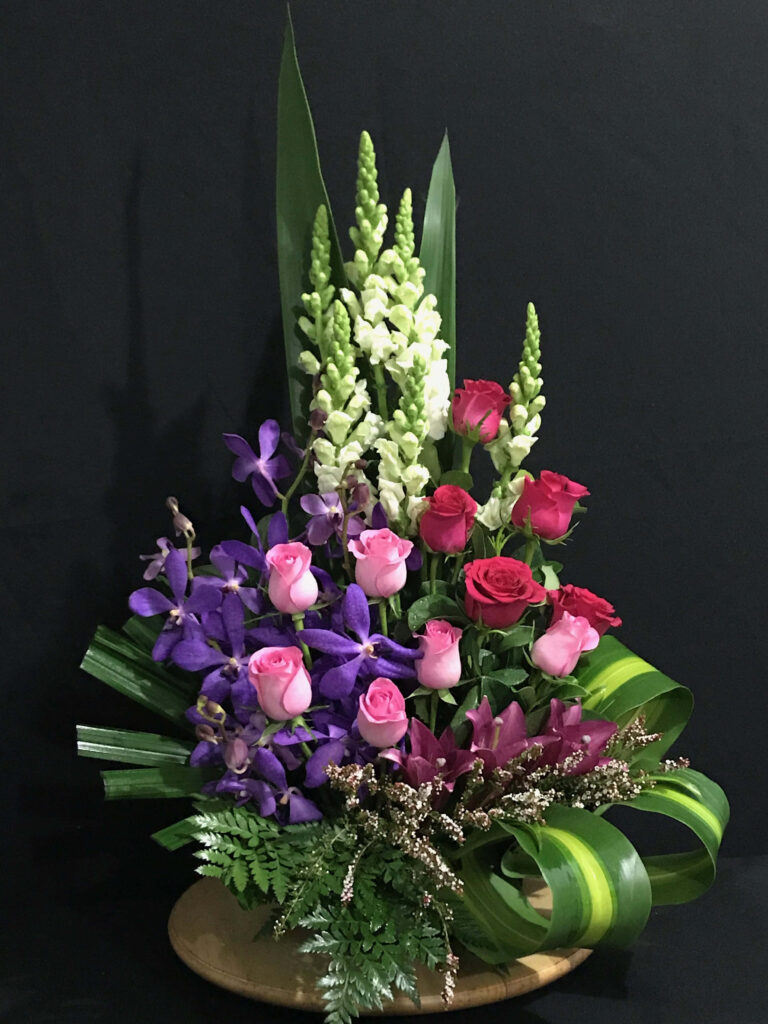 Elegant Floral Wallpaper: Vibrant Orchids & Roses on Dark Background