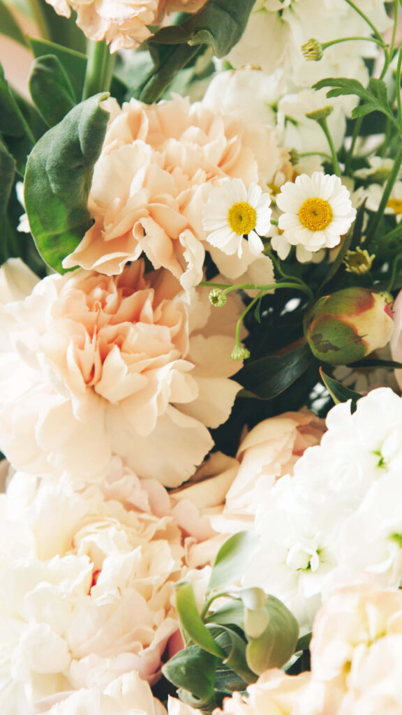 Elegant Floral Wallpaper: Soft Peach & White Flowers with Green Leaves