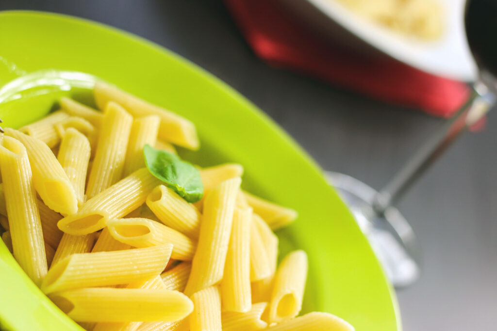 Elegant Fresh Penne Pasta on Green Plate - Wallpaper Background