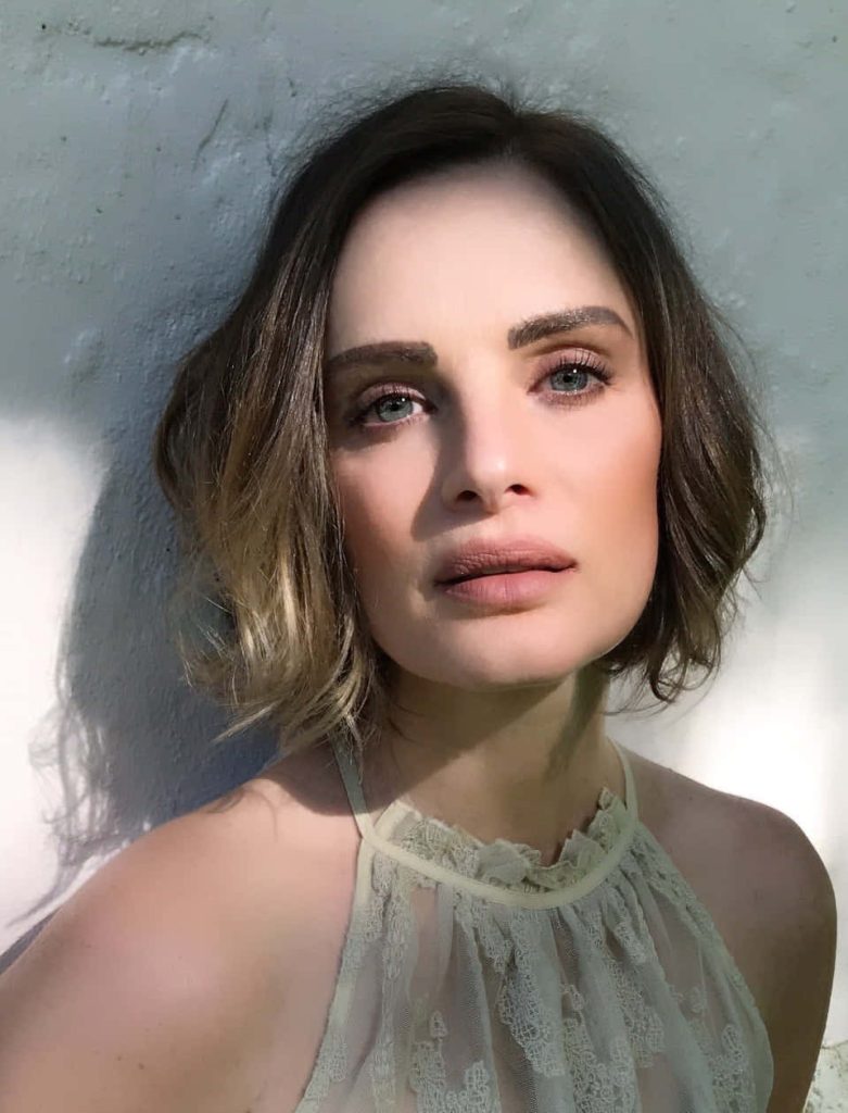 Gabrielle Anwar portrait with textured bob lace halter top soft side lighting dramatic shadows Wallpaper