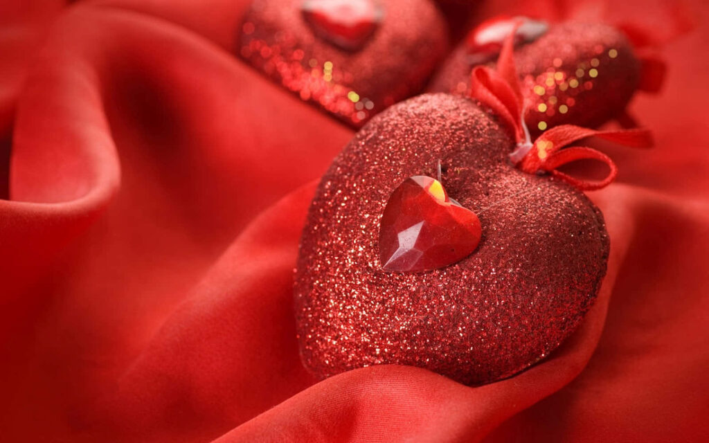 Elegant Red Heart with Jewel Center on Vibrant Fabric Wallpaper