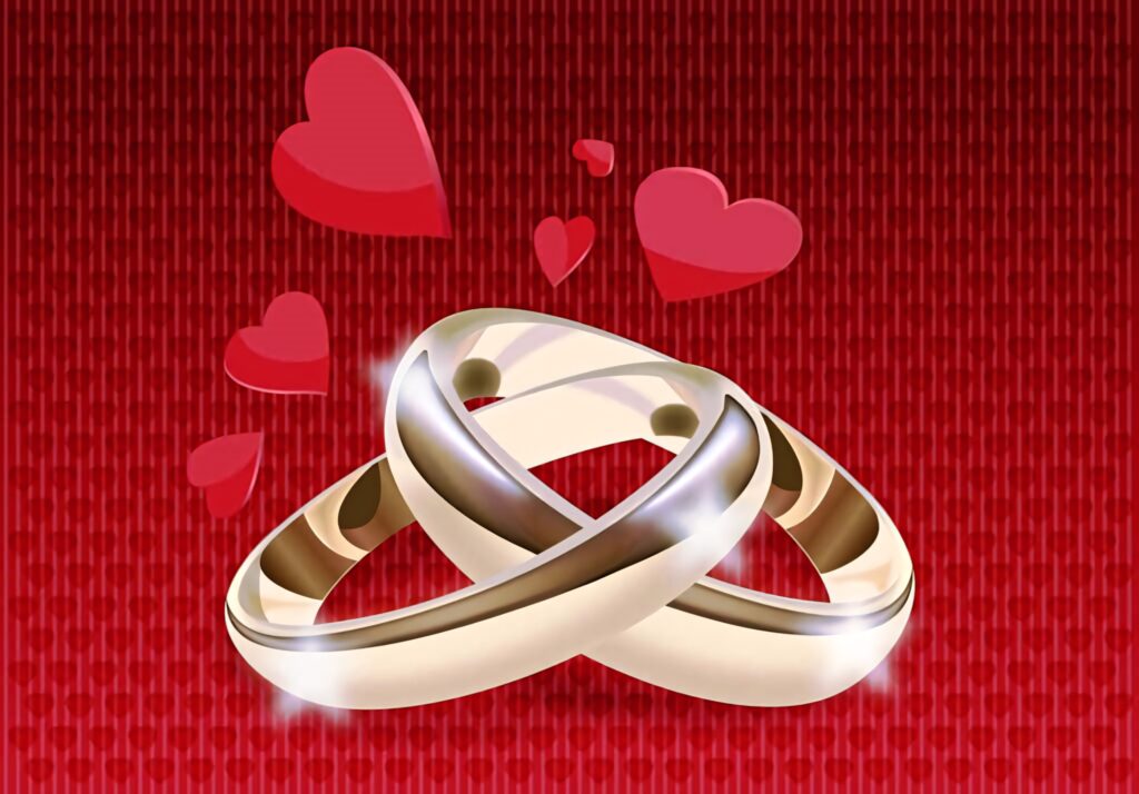 Two gold engagement rings on textured red background with floating hearts symbolizing love romance Wallpaper