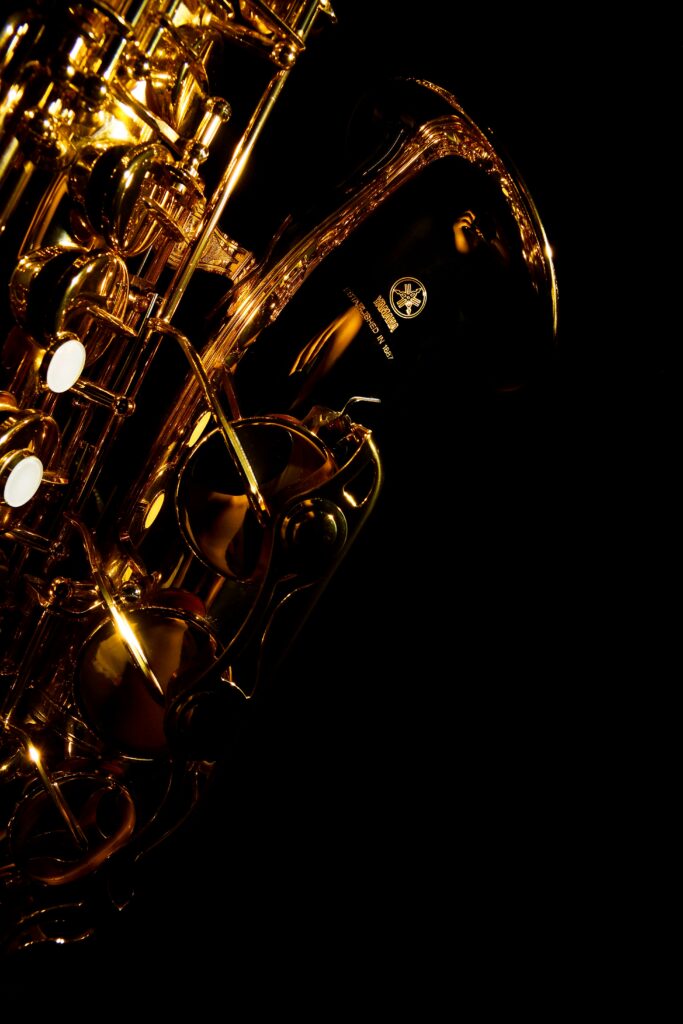 Elegant Gold Brass Instrument Wallpaper on Black Background