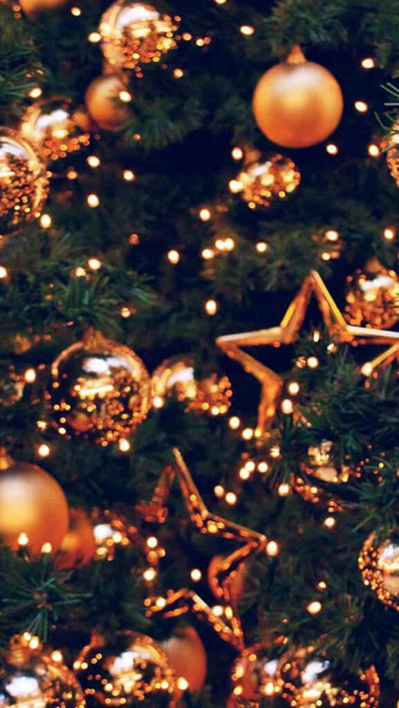 Elegant Golden Christmas Decorations on Lush Green Tree Background Wallpaper