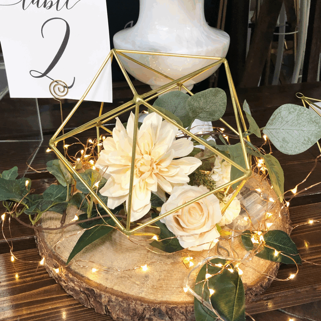 Elegant wallpaper with golden geometric frame cream roses dahlias greenery fairy lights wood slab
