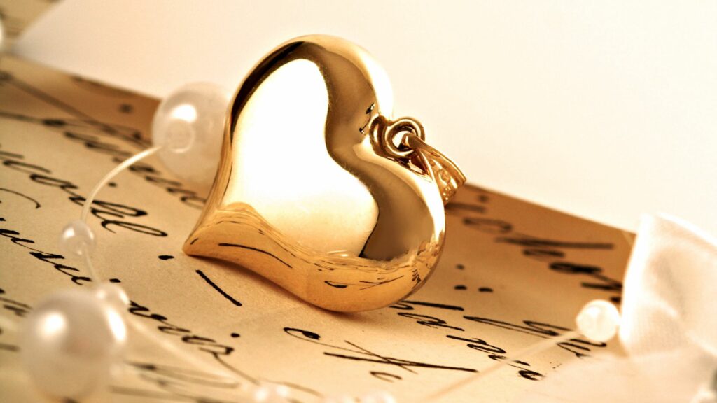 Elegant Golden Heart Pendant on Handwritten Letters - Love Wallpaper