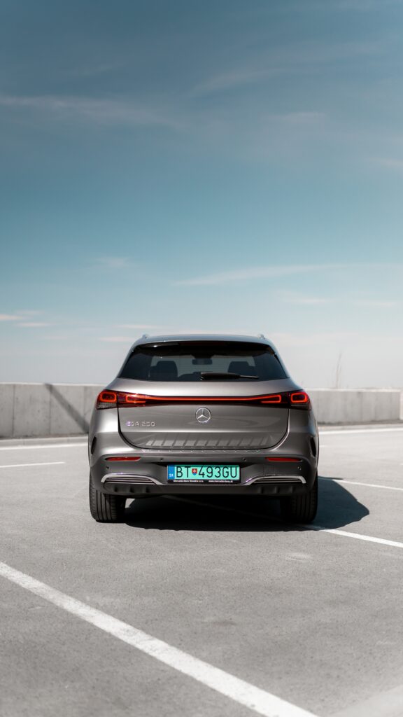 Sleek Gray Mercedes EQA 250: Elegant Back View Against Blue Sky Wallpaper
