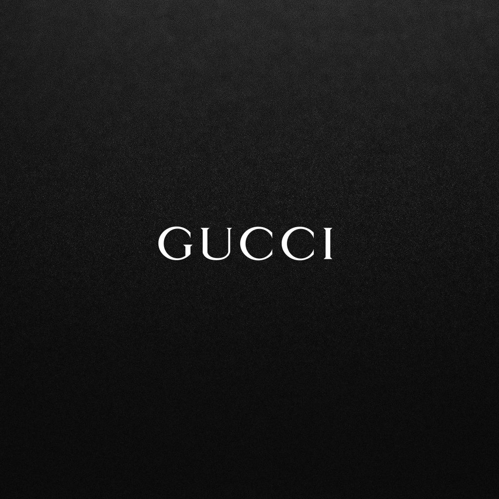 Gucci logo wallpaper on textured matte black background luxury minimalist digital design