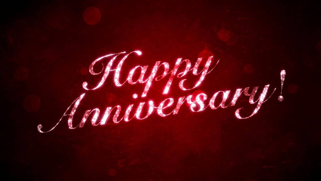 Elegant Happy Anniversary wallpaper with glittery white script on deep crimson bokeh background