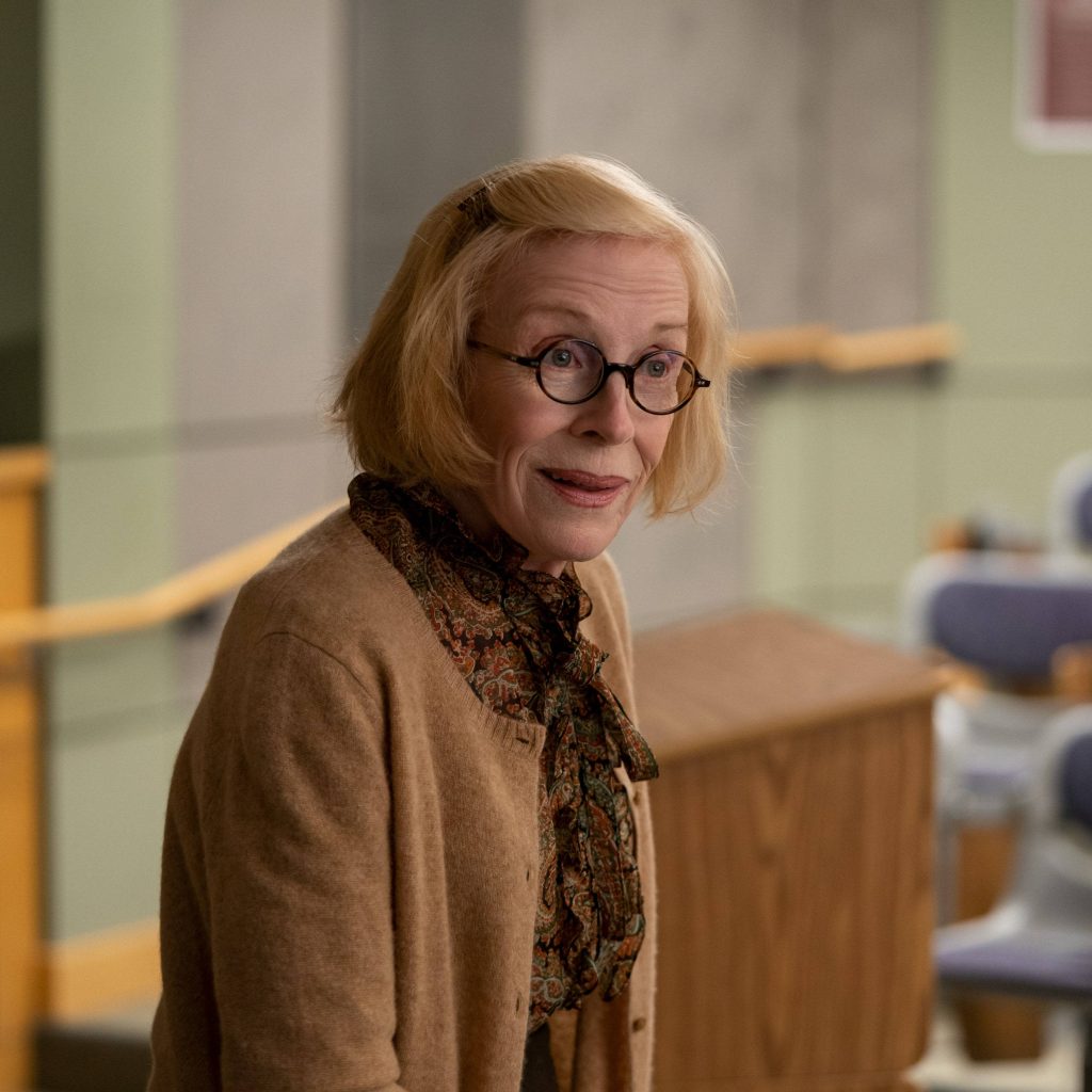 Holland Taylor in soft light wearing glasses tan cardigan patterned blouse professional portrait Wallpaper