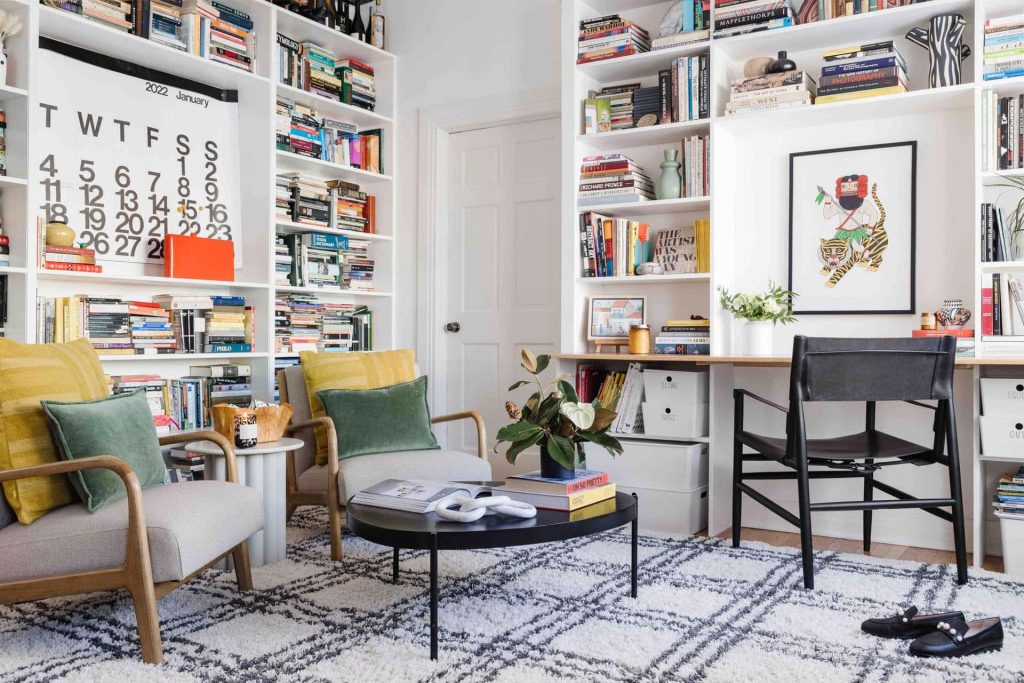 Bright home library Zoom background with stylish armchairs and cozy professional workspace Wallpaper