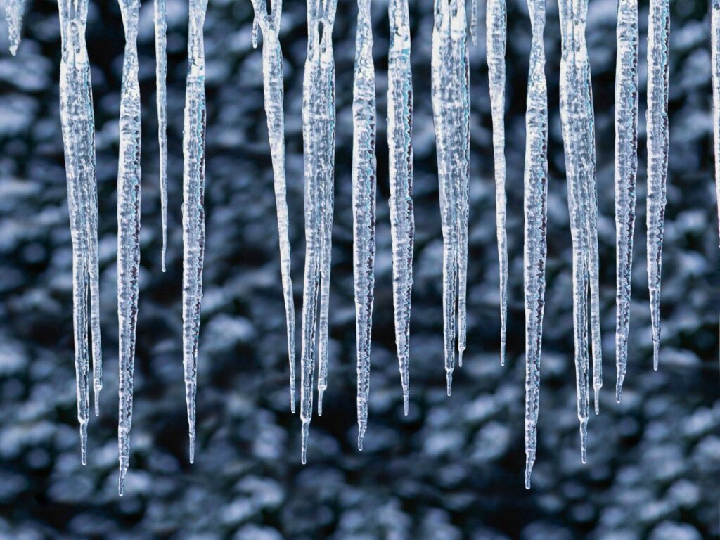 Intricate Frost Patterns on Hanging Icicles – Winter Wallpaper Background