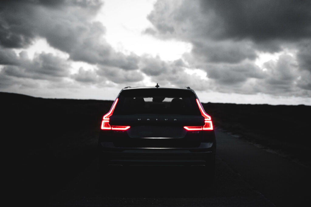 Elegant Black Land Rover Wallpaper with Dramatic Cloudy Sky