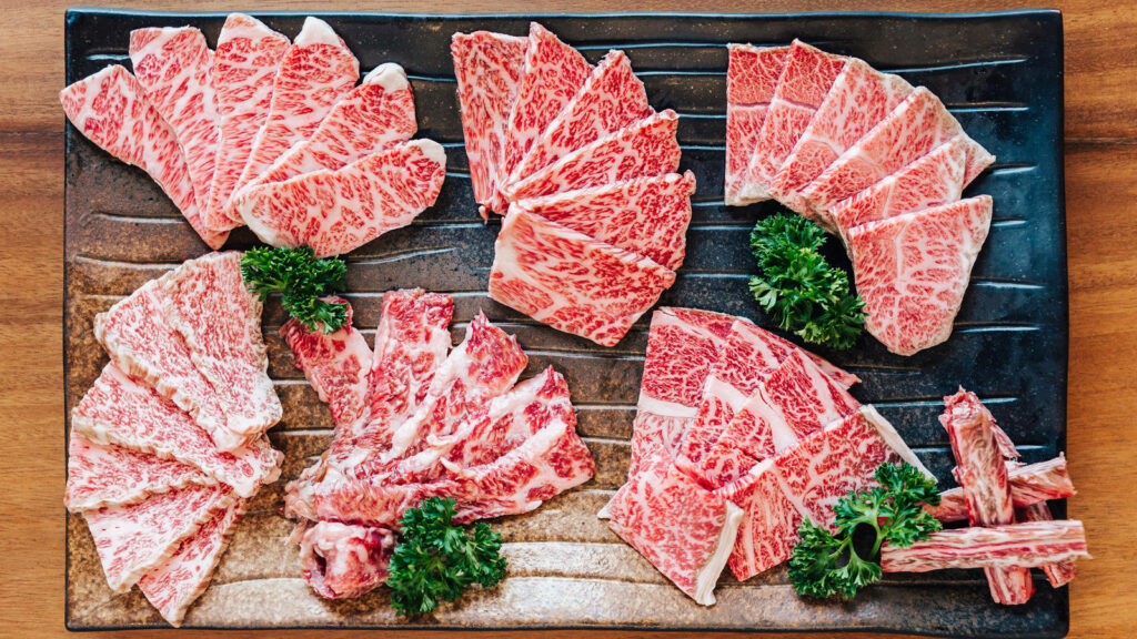 Elegant Kobe Beef Display: Marbled Perfection on a Stylish Platter Wallpaper