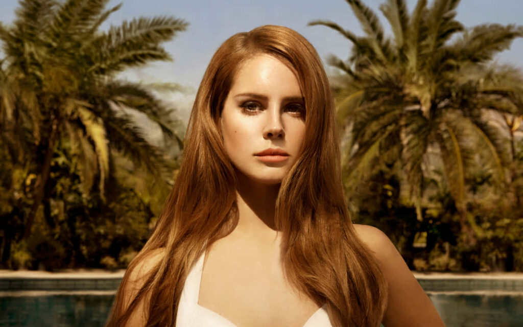 Elegant Lana Del Rey Poolside Wallpaper with Lush Palm Trees