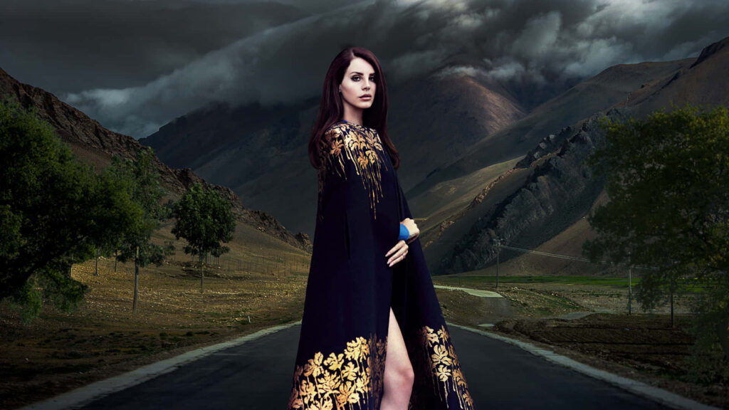 Lana Del Rey Elegant Wallpaper: Graceful Pose & Stormy Mountains