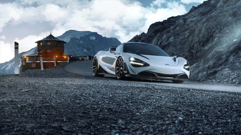 Elegant McLaren Racing Car Wallpaper on Rugged Mountain Road