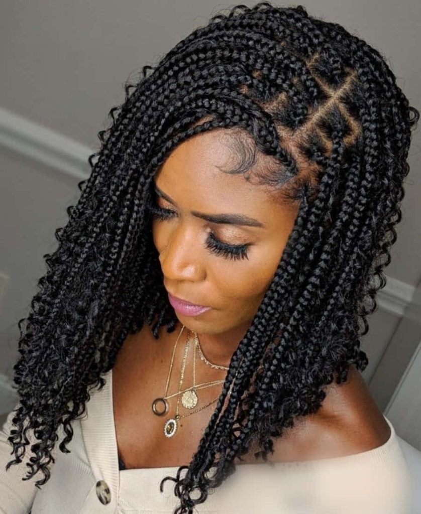 Elegant portrait of woman with medium knotless braids curly ends gold necklaces and baby hairs Wallpaper