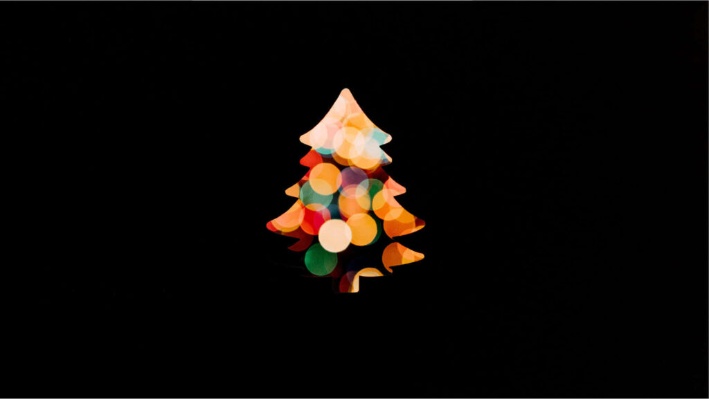 Minimalist Christmas Wallpaper: Black Background & Colorful Tree Lights