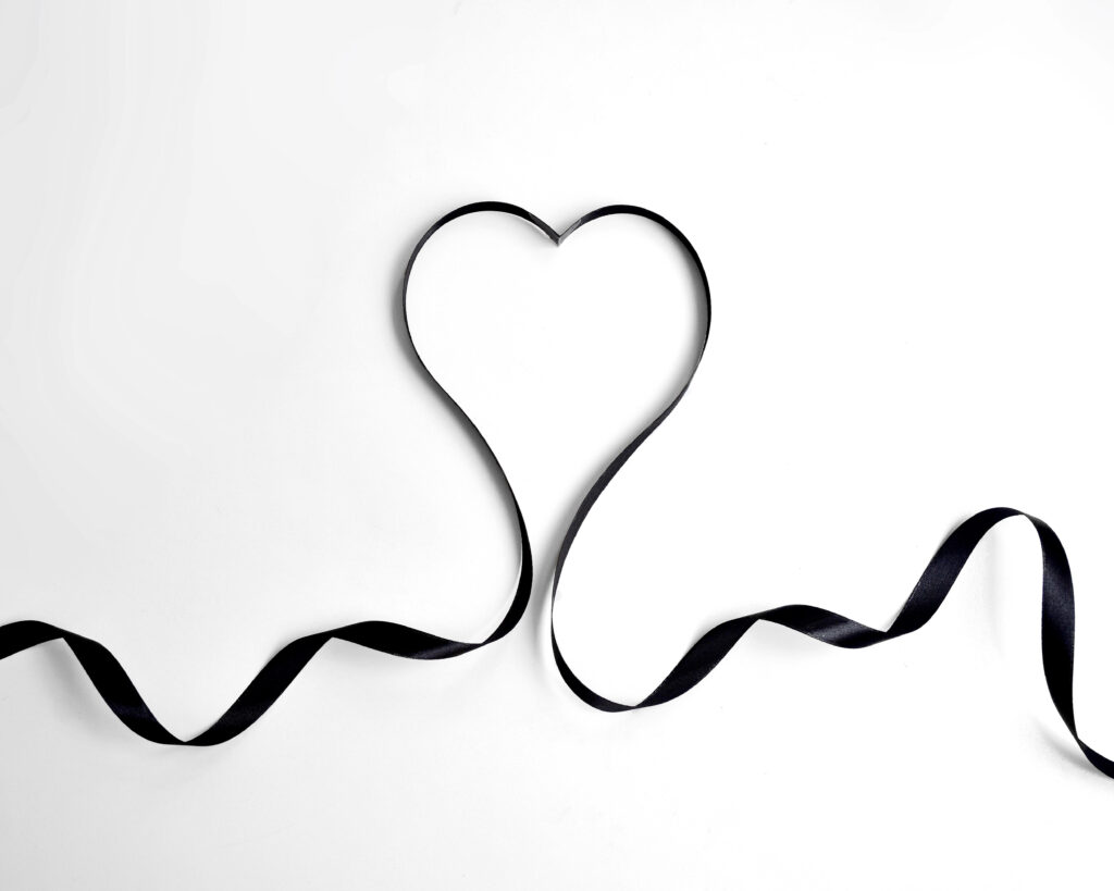Minimalist Heart Wallpaper: Elegant Black Ribbon on White Background