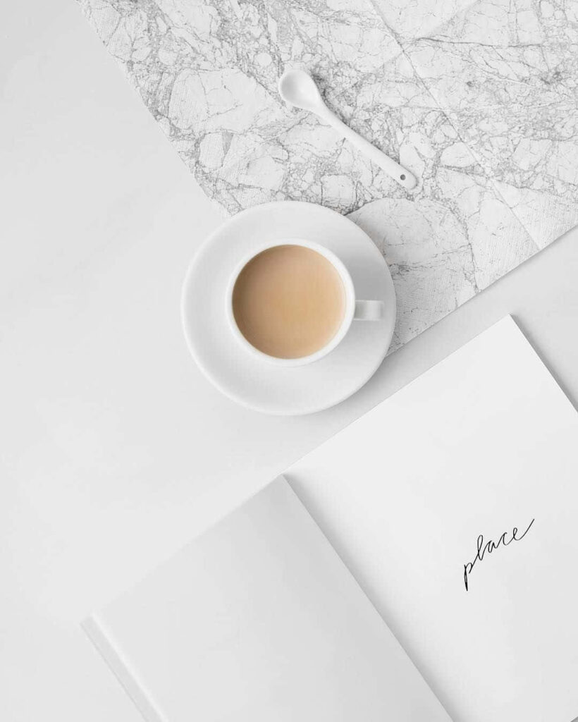 Minimalist Marble Workspace Wallpaper: Coffee, Book & Elegance