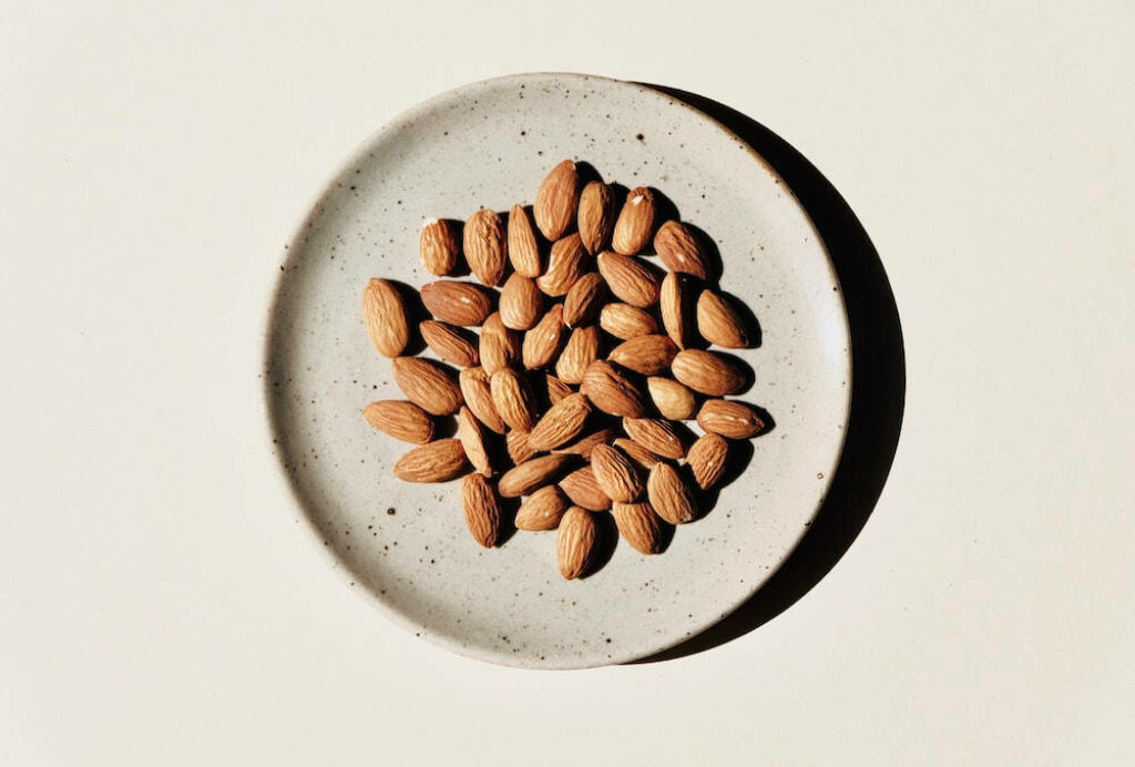 Elegant Almonds Wallpaper: Minimalist Plate on Neutral Background