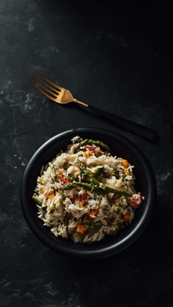 Elegant Mixed Vegetable Rice Dish in Dark Bowl - Wallpaper Background