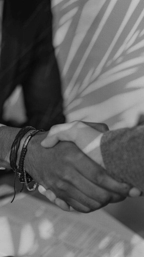 Monochrome Handshake Wallpaper: Shadows of Connection & Unity