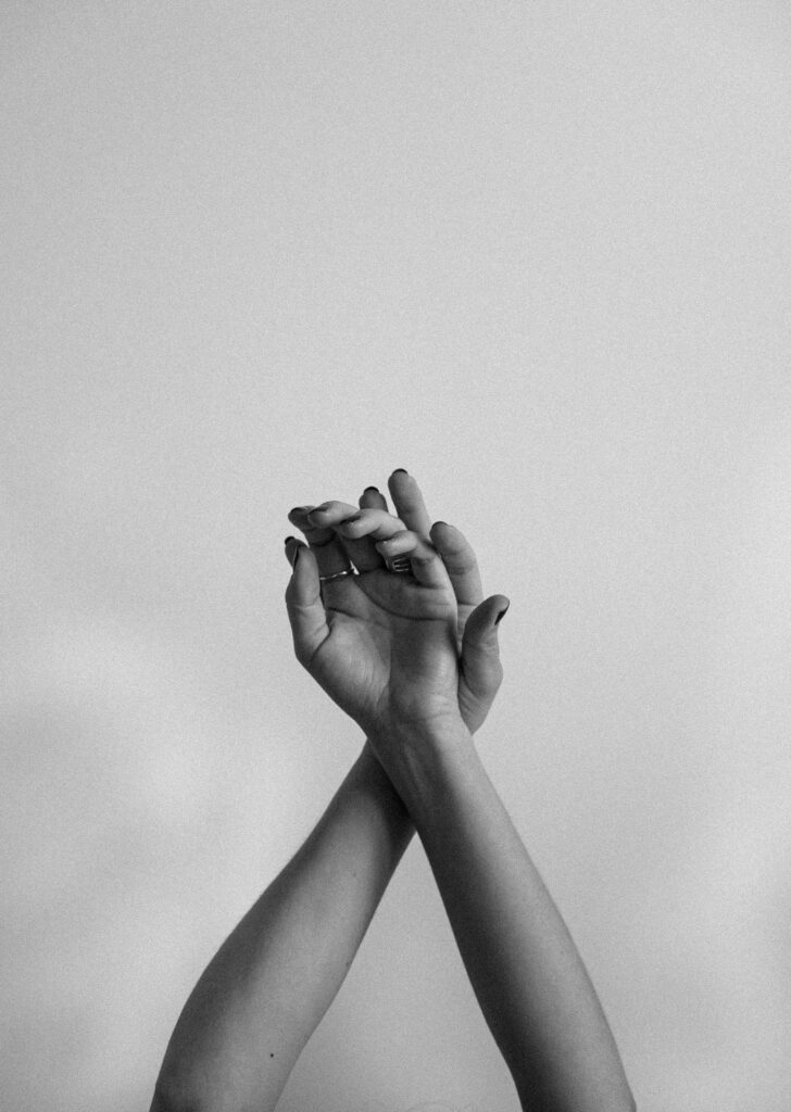 Elegant Monochrome Image of Woman's Hands Raised in Freedom Wallpaper