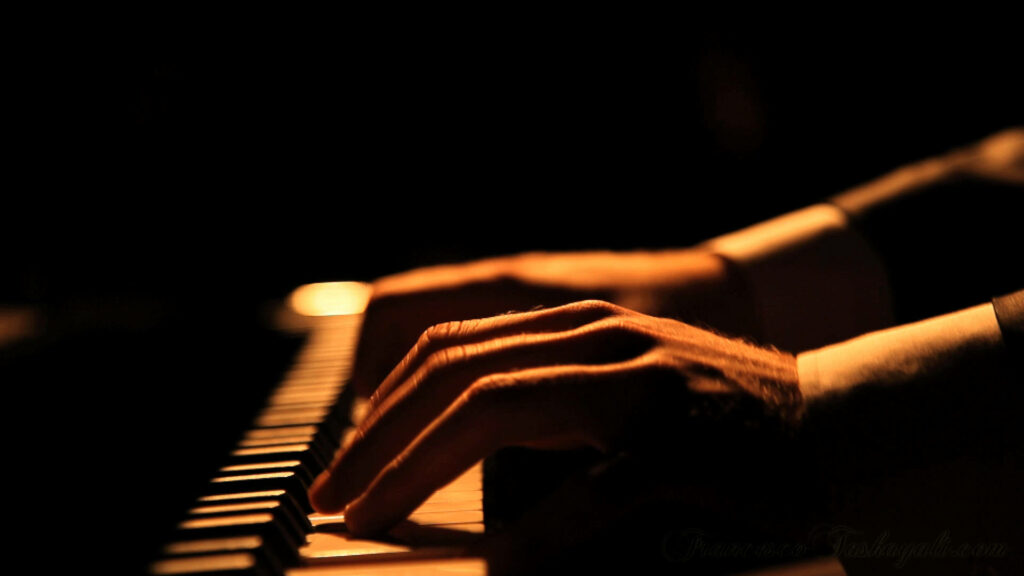 Elegant Musician's Hands Playing Piano - Serene Wallpaper Background
