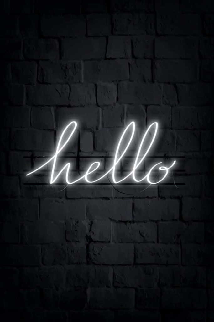 Elegant ‘Hello’ Neon Script Wallpaper on Dark Brick Background