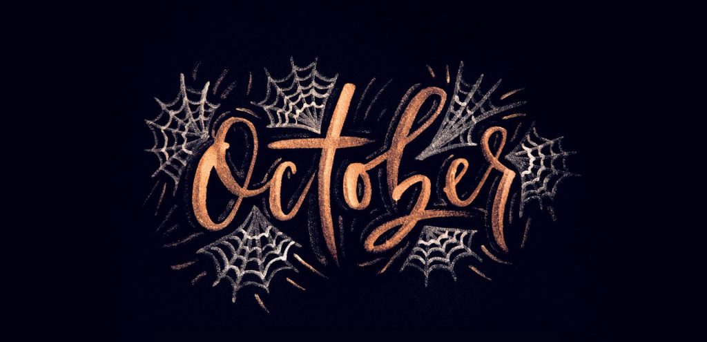 Festive Halloween wallpaper with metallic copper October text on black background and white spiderwebs