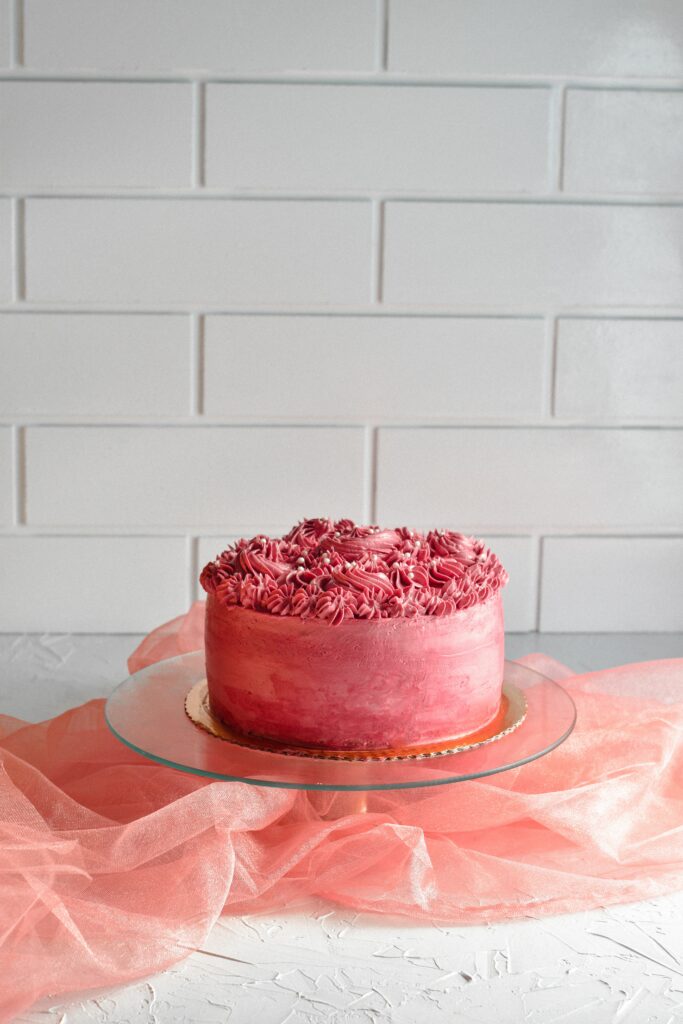Elegant Pink Cake with Intricate Cream Designs - Stylish Wallpaper