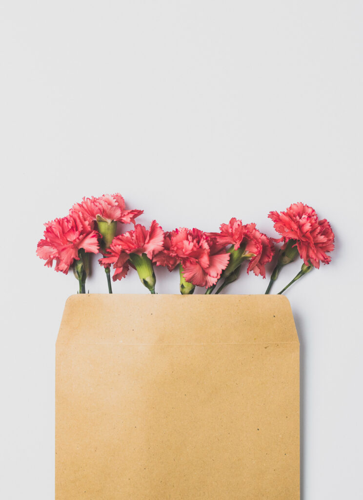 Elegant Pink Carnations in Rustic Envelope - Charming Background Wallpaper