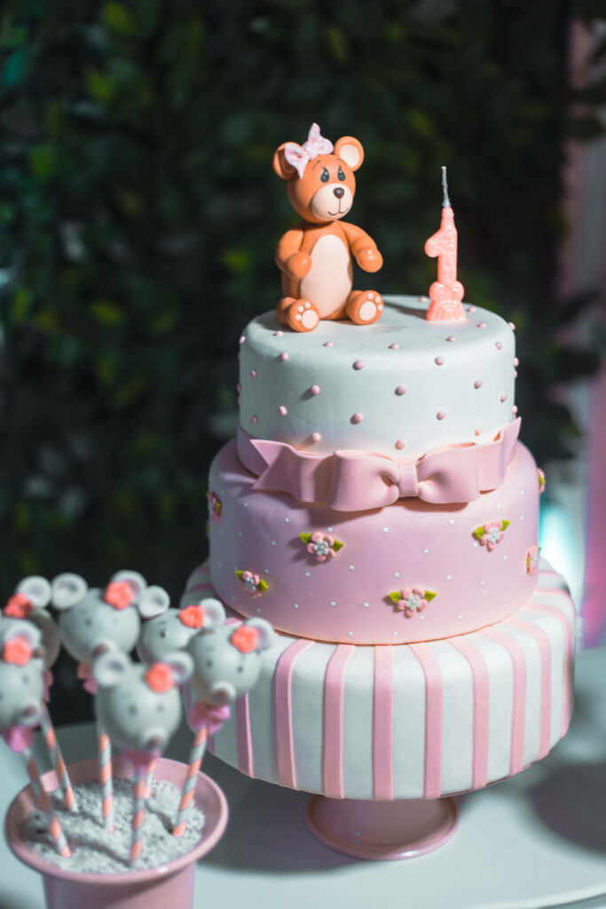 Elegant Pink Cake with Teddy & Candle - Perfect First Birthday Background Wallpaper