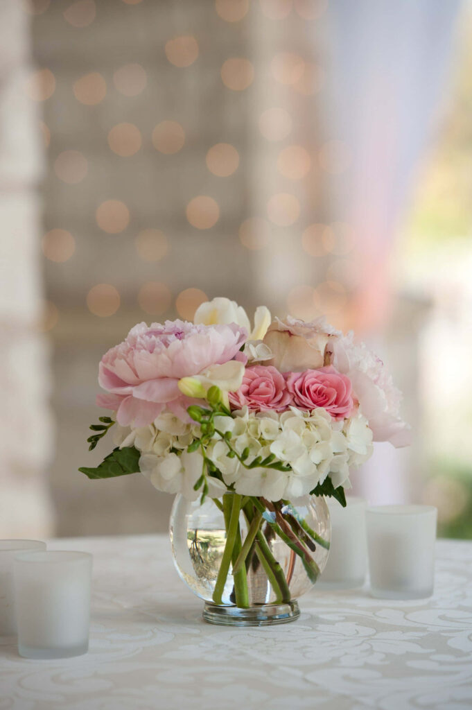 Delicate pink peonies roses and white hydrangeas in glass vase elegant floral centerpiece Wallpaper