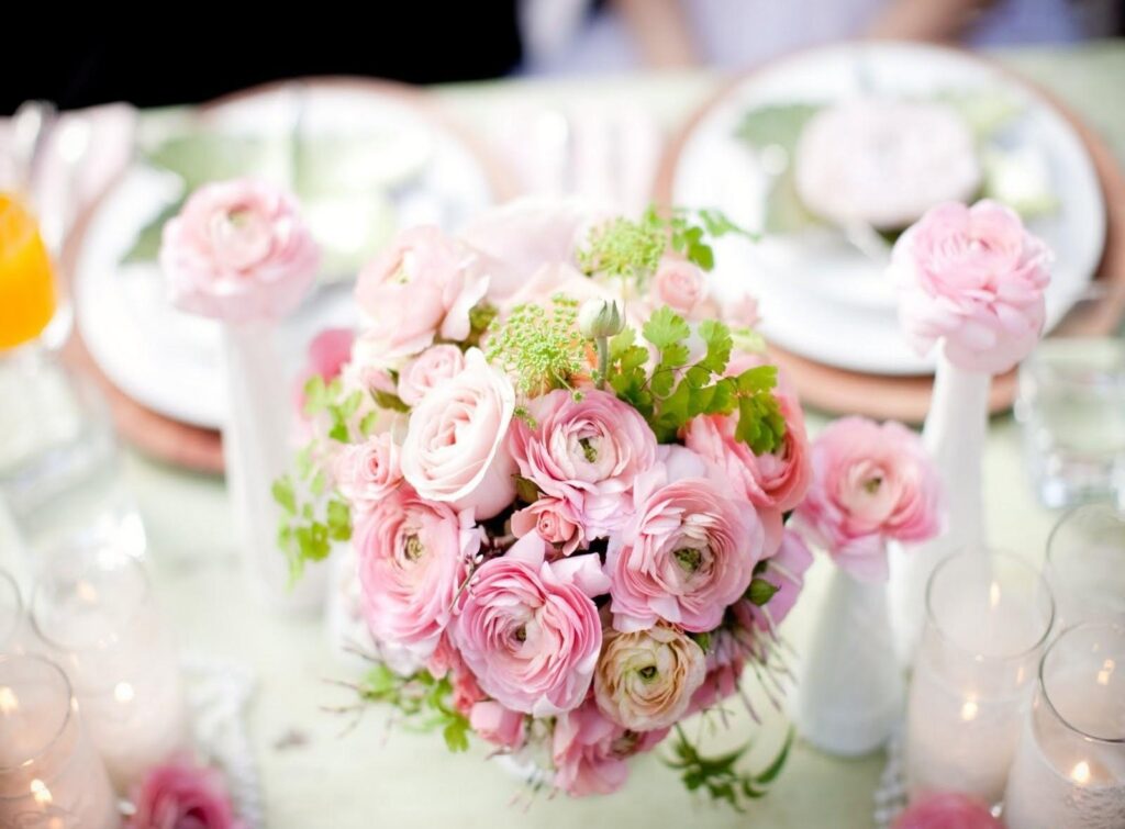Serene Pink Ranunculus Bouquet Wallpaper with Candles Background