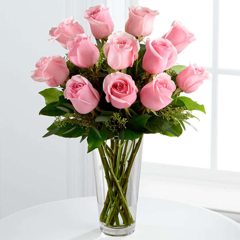 Elegant Pink Roses in Glass Vase - Serene Floral Background Wallpaper