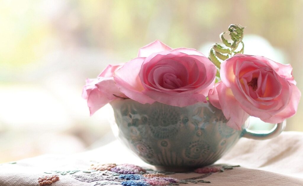 Elegant Pink Roses in Ornate Cup | Dreamy Floral Background Wallpaper