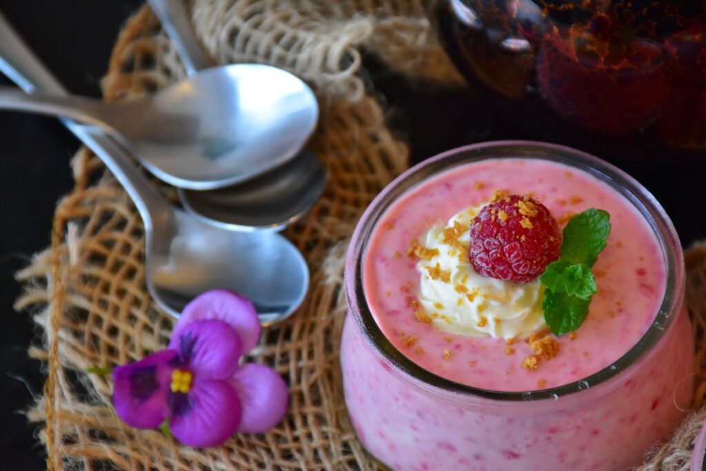 Elegant Raspberry Mousse Dessert with Whipped Cream & Mint Wallpaper