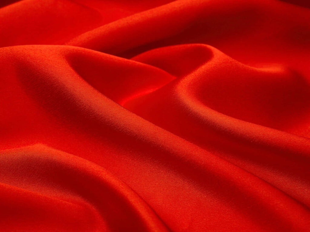 Elegant Red Fabric Wallpaper: Luxurious Texture & Soft Folds